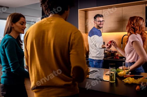 Preview: Group of friends having dinner party at home drinking wine and eating vegetarian food.