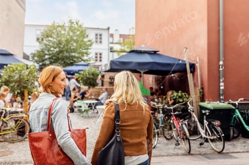 Preview: Two female friends walking in city