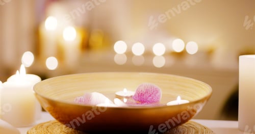 Preview: Spa, candles and bowl of flowers for massage as objects in desk for relaxation, luxury and stress r