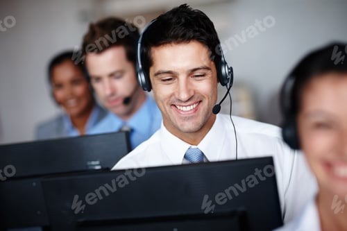 Preview: Pleased to assist you. A handsome young call center agent enjoying his job tremendously.