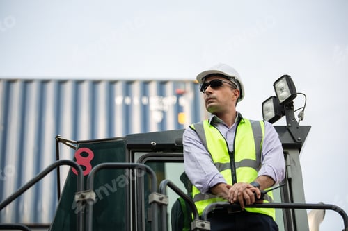 Preview: Logistic manager standing on the forklift truck inspecting at the distribution warehouse