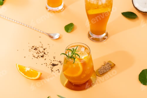 Preview: Fresh cocktails with orange isolated on a peachy background