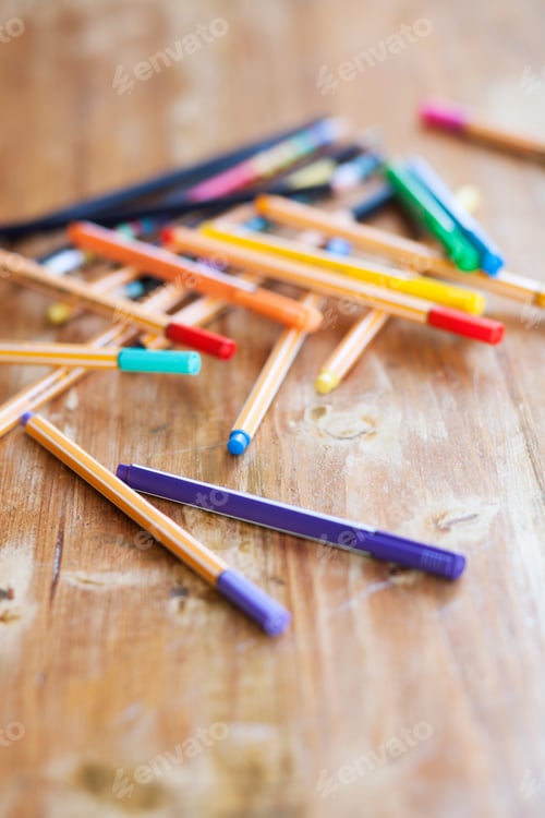 Preview: Directly above shot of colorful felt tip pens on wooden table