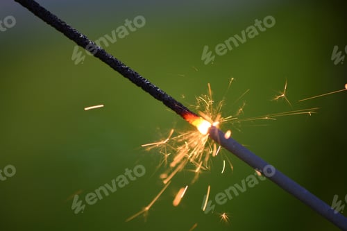 Preview: Close Up of Sparkler on Green Background