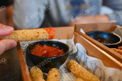 Preview: A boy holding a delicious golden-brown mozzarella cheese stick