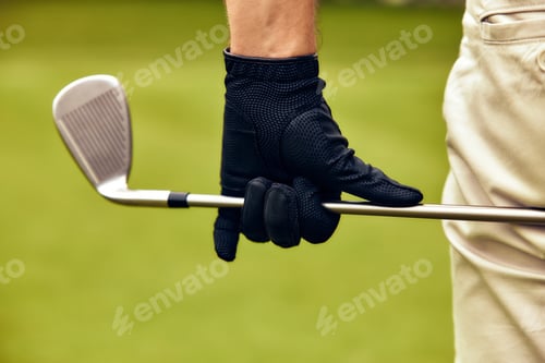 Preview: A closeup view of a golfer skillfully holding an iron club while wearing a black glove