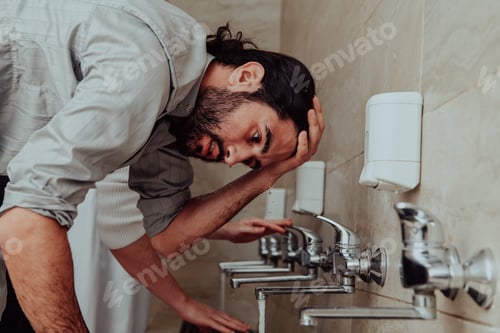 Preview: A Muslim performing ablution. Ritual religious cleansing of Muslims before performing prayer. The