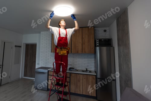 Preview: Man Installing a Light Fixture in a Kitchen