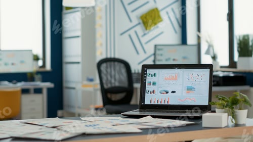 Preview: Empty startup office with laptop showing business mangement software on display showing moving