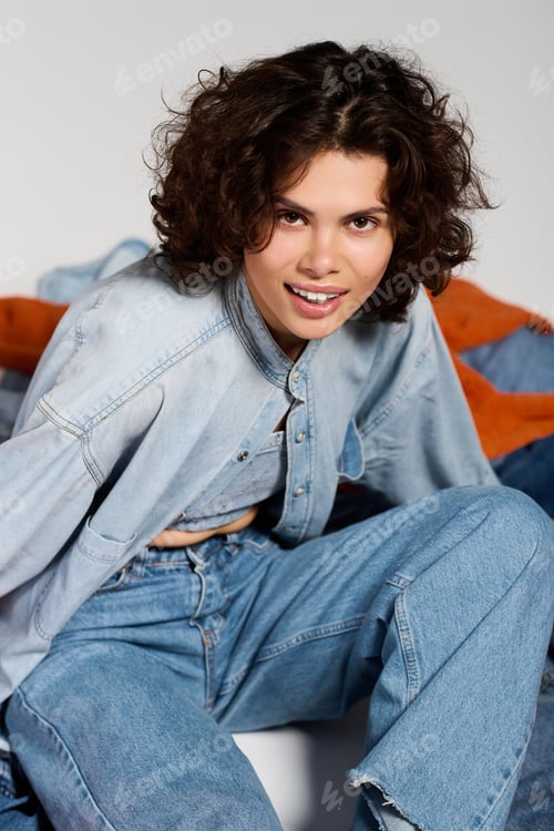 Preview: Fashionable young woman showcasing trendy denim style in a modern indoor setting