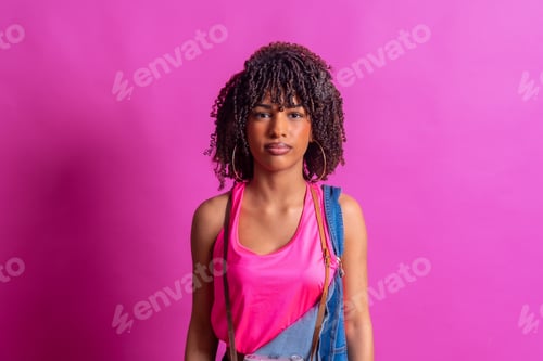 Preview: Young photographer posing with vintage camera on pink background