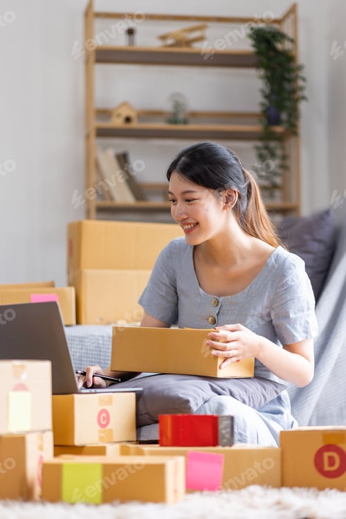 Preview: Young Asian woman small business owner SME online marketing at home. confirm orders from customers p