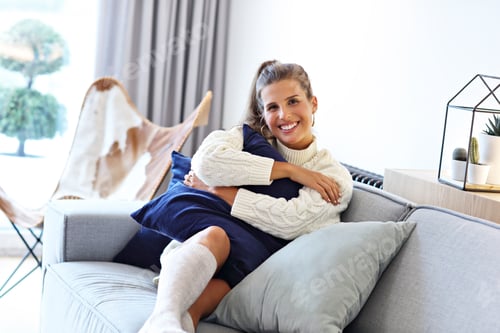 Preview: Adult woman wearing warm sweater resting at home one autumn day