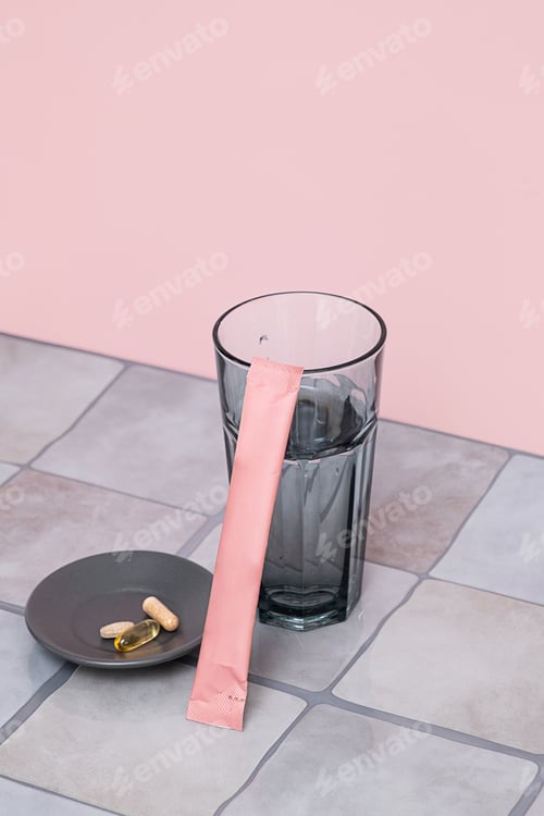 Preview: Nutritional supplement powder packet with glass of water and natural medicine pills