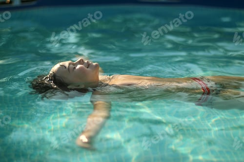 Preview: A boy swims in the pool on a hot day