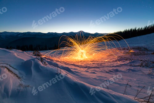Preview: Light painting art. Spinning steel wool in abstract circle, firework showers