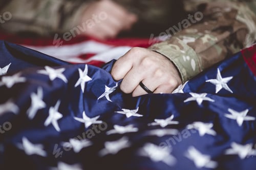 Preview: American soldier mourning and praying with the American flag in front of him