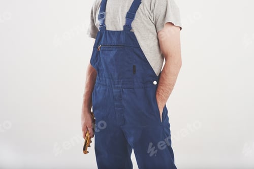 Preview: Cropped photo. Man in blue uniform stands against white background in the studio