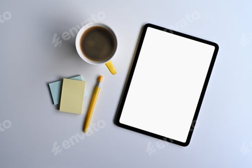 Preview: Mockup digital tablet, coffee cup and sticky notes on office desk. Top view.