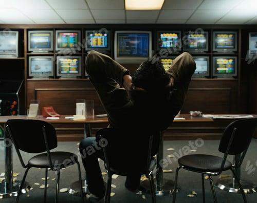 Preview: Man sitting in a betting shop