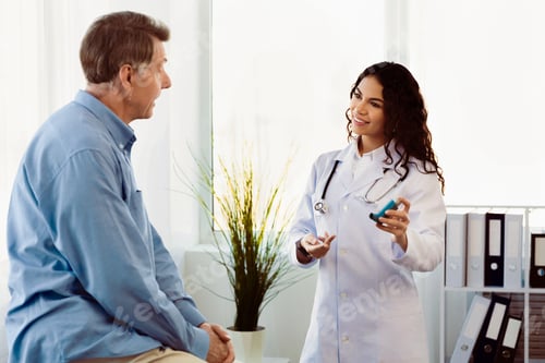 Preview: Doctor Explains Inhaler Use to Patient in Office