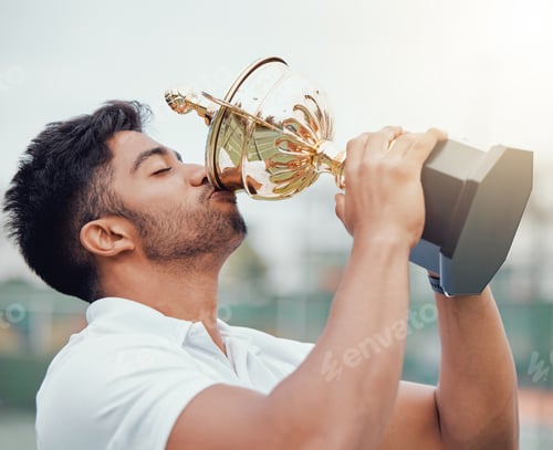 Preview: One indian tennis player drinking from a trophy while celebrating success after winning a court gam