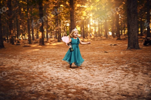 Preview: Shot of a happy little girl holding a lamp while running around outside in the woods