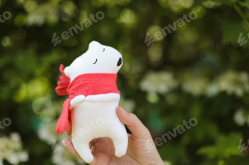 Preview: Eco-friendly cute handmade toy bear on grass at sunny summer day.