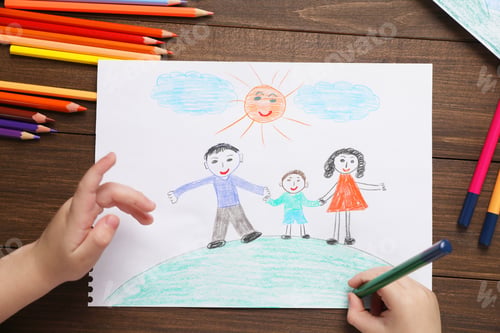 Preview: Little boy drawing with pencil at wooden table, top view. Child`s art
