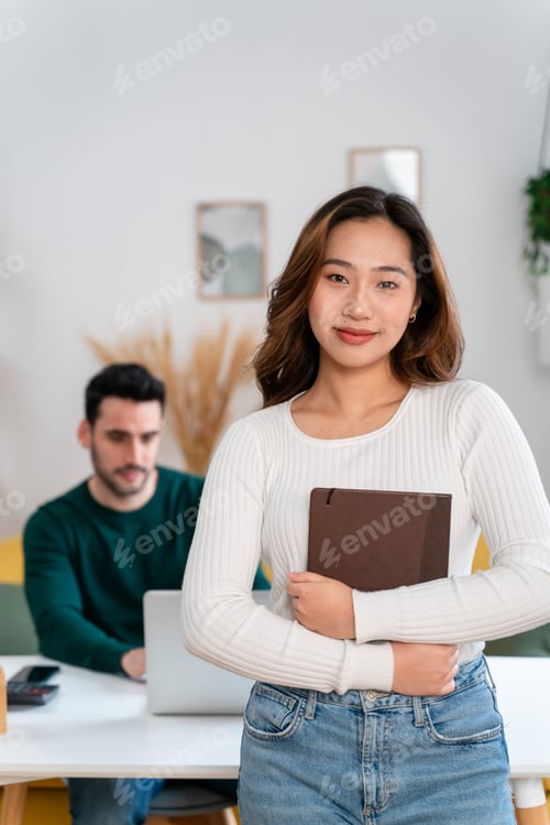 Preview: Smiling woman with notepad in living room