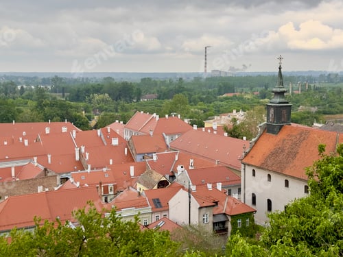 Preview: Scenic view of red rooftops with green trees in the old town of Petrovaradin, Serbia