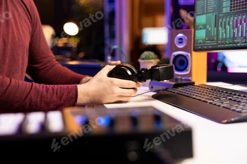 Preview: Artist preparing electronic gear for audio recording session in his home studio