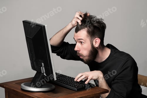 Preview: Funny And Crazy Man Using A Computer On Gray Background. Man'S Hands On The Keyboard