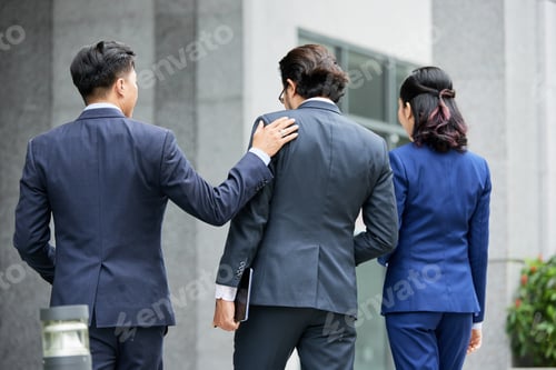 Preview: Group of elegant businesspeople walking on street