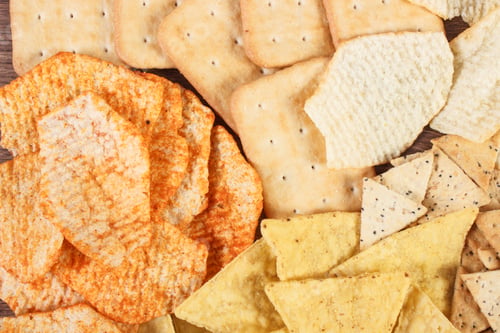 Preview: Heap of salted crisps and cookies, concept of unhealthy food