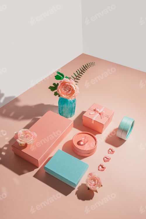 Preview: Festive geometric arrangement of gift boxes and flowers in pastel colors with sunny shadows