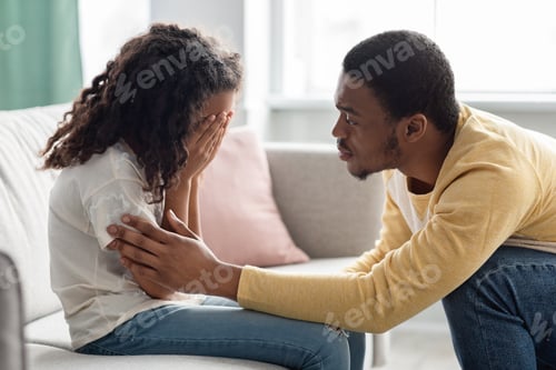 Preview: Black father comforting his crying kid, home interior