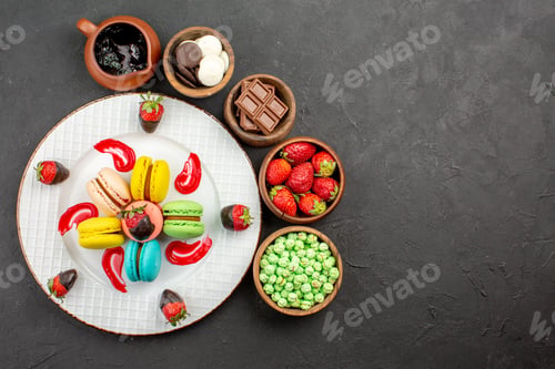 Preview: top view from afar strawberries and macaroons plate of appetizing French macaroons and strawberries