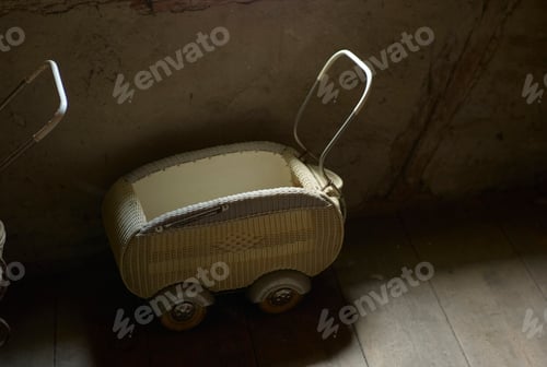 Preview: An old wicker baby carriage in a dimly lit room.