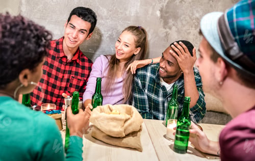Preview: Millenial friends group drinking bottled beer and having fun at fashion cocktail bar