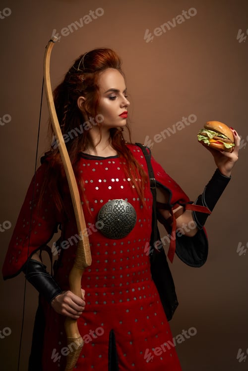 Preview: Red haired female warrior with bow keeping hamburger