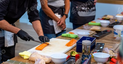 Preview: Sushi cooking workshop. Master sushi chef cutting a salmon loin.