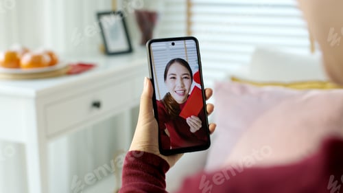 Preview: videocall shot of attractive beautiful young asian lady in red chinese new year