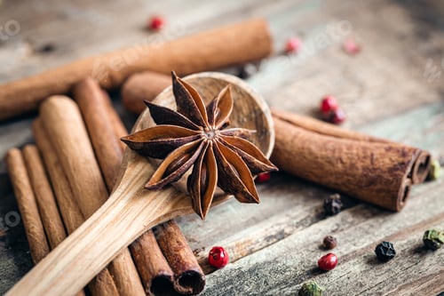 Preview: Composition with star anise and cinnamon sticks on a wooden background.