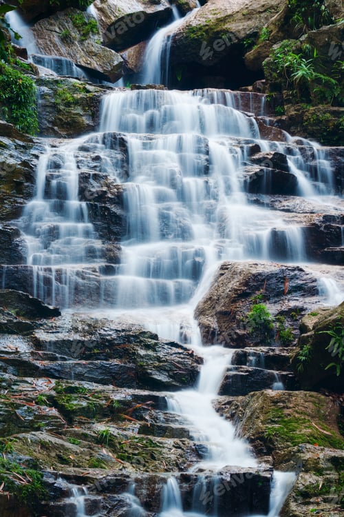 Preview: Waterfall cascading over rocky terrain in tropical forest at Vietnam