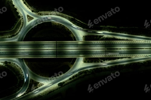 Preview: Aerial drone top view of a modern motorway junction roundabout with cars moving. Transportation