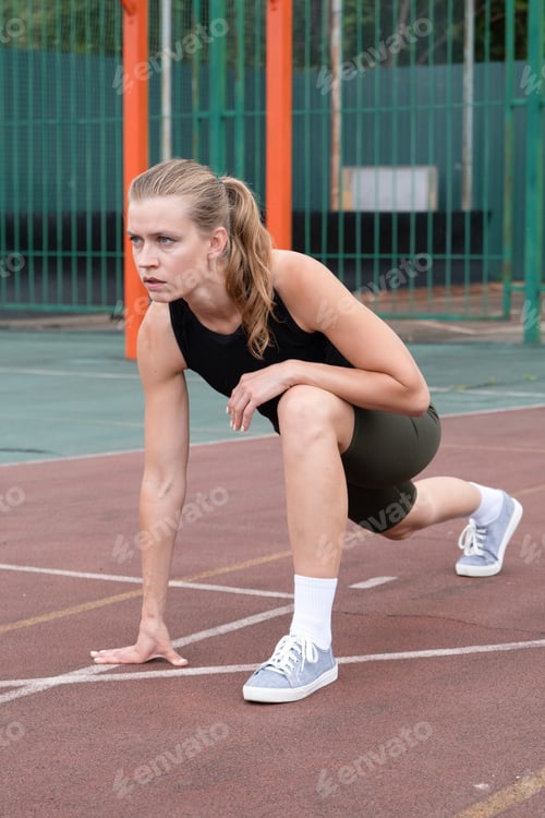 Preview: Caucasian sportive female boxer training at the stadium, warming up and stretching