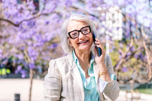 Preview: mature woman smiling happy talking on mobile phone