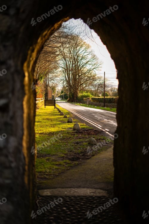 Preview: Stone arch in foreground, road leading into Northern Irish countryside in background