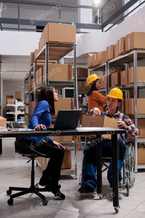 Preview: Delivery manager and coworker in wheelchair preparing parcels shipment